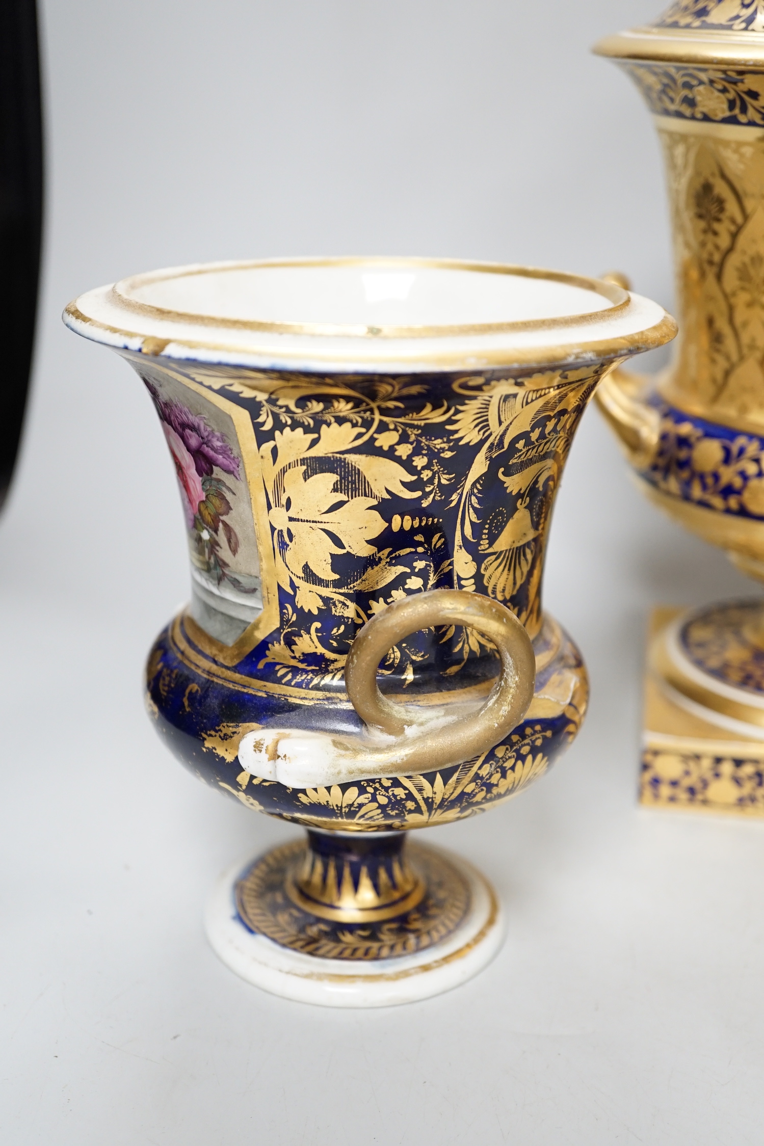 A pair of Derby flower basket painted urns, c.1810, and a larger Derby urn and cover, first quarter 19th century, latter 30cm